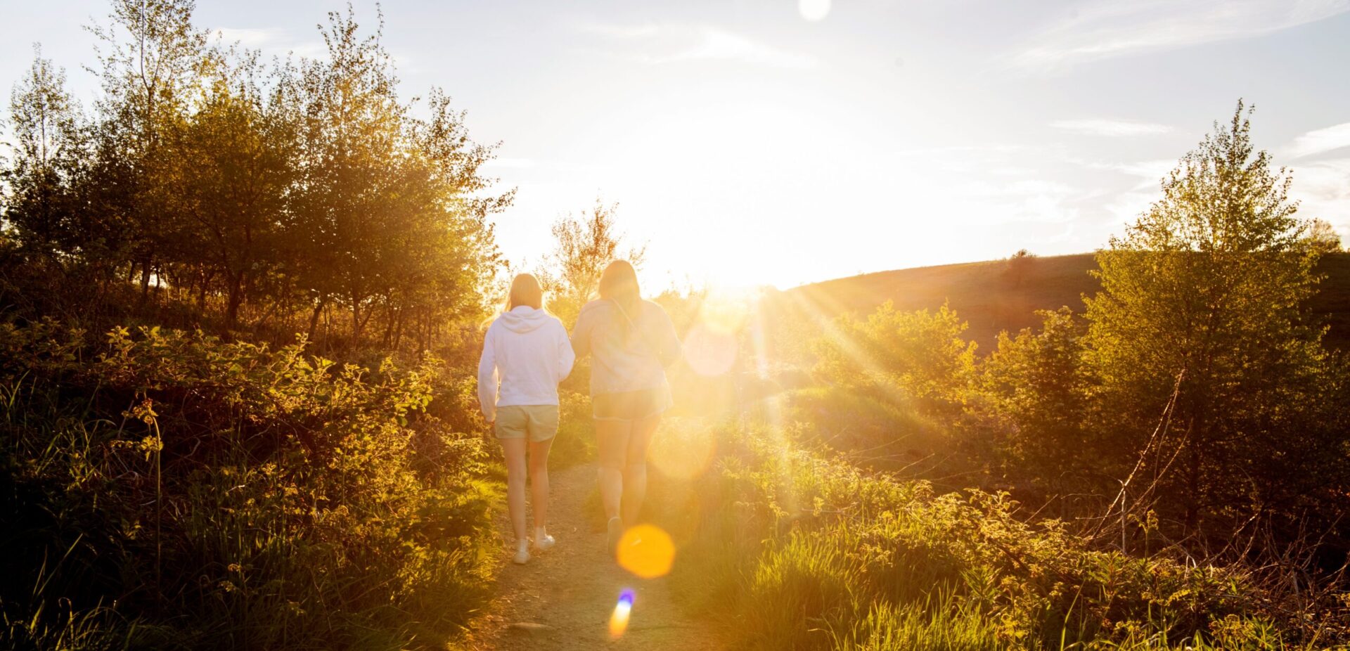 Young people walking outside at sunset