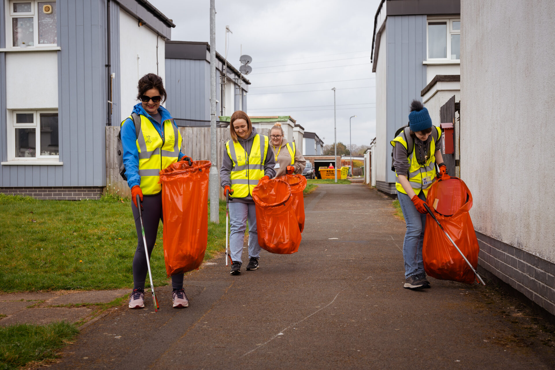 A group of four employees litter picking on a housing estate